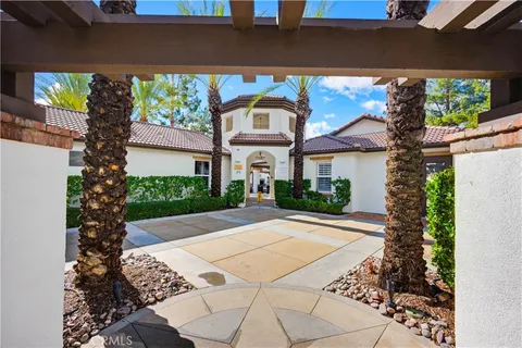 a view of a backyard with a garden and patio