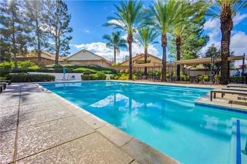 a view of a swimming pool with a garden and trees