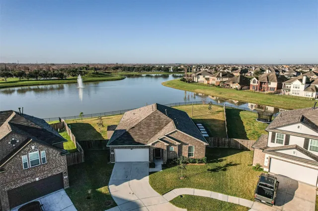 an aerial view of a house with swimming pool garden and seating