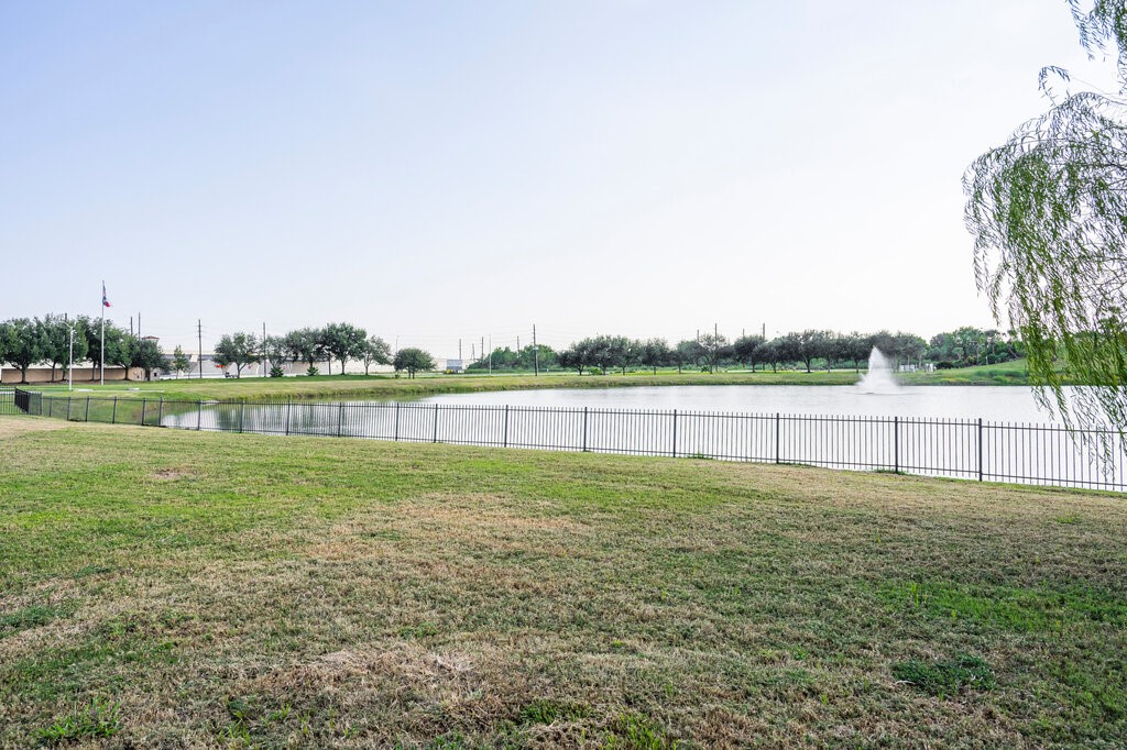 105 Montecito Lane Manvel, TX 77578 - Photo 14 of 39 a view of a green field with a lake view