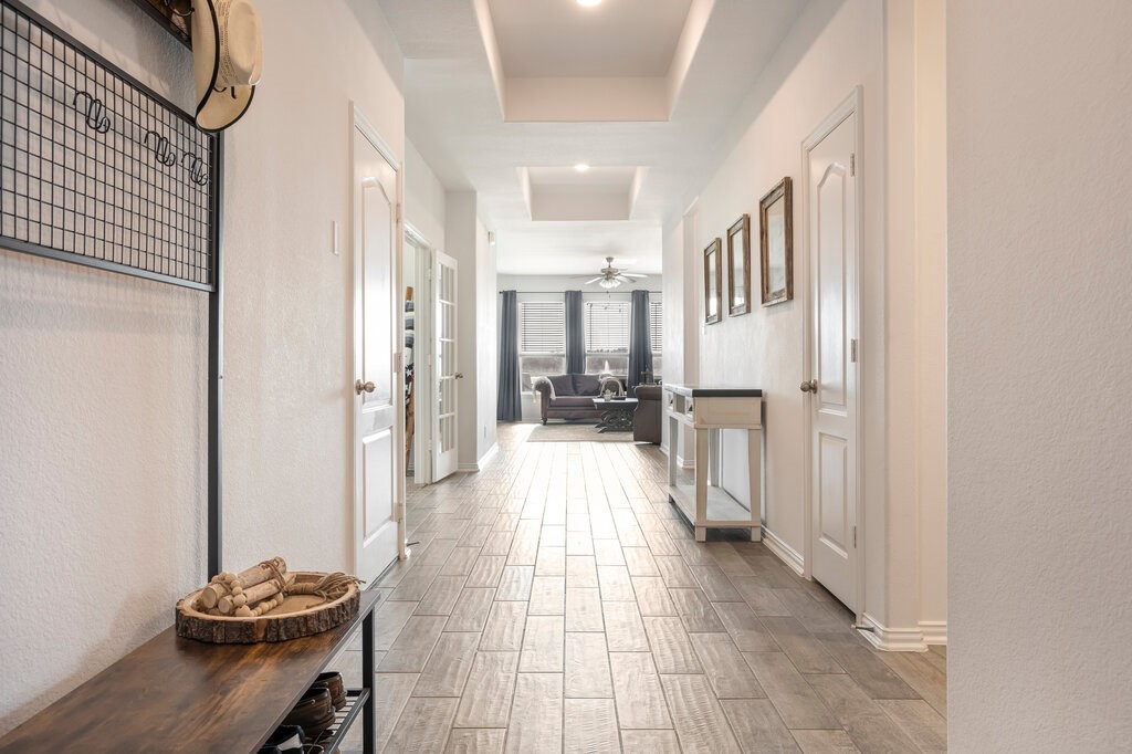 105 Montecito Lane Manvel, TX 77578 - Photo 18 of 39 a view of a hallway with dining area and chandelier