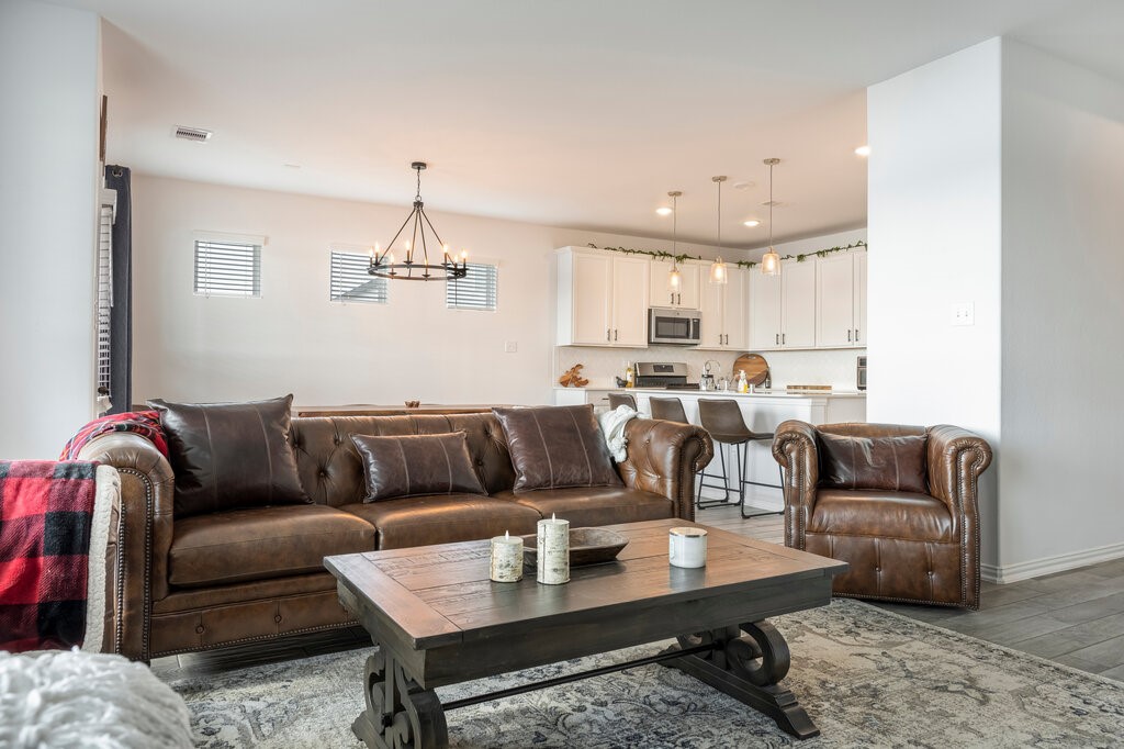 105 Montecito Lane Manvel, TX 77578 - Photo 20 of 39 a living room with furniture and a chandelier