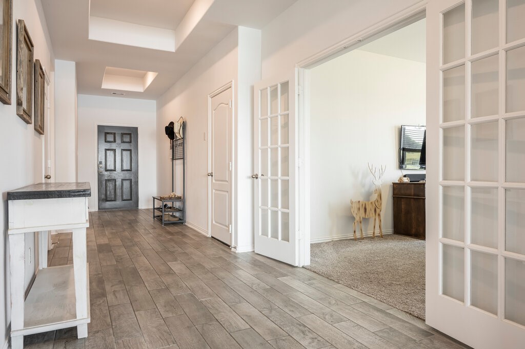 105 Montecito Lane Manvel, TX 77578 - Photo 23 of 39 a view of a livingroom with wooden floor and a kitchen