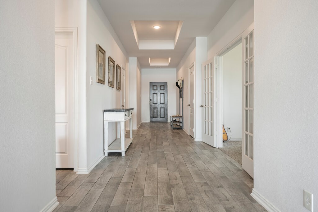 105 Montecito Lane Manvel, TX 77578 - Photo 24 of 39 a view of a hallway with wooden floor and closet