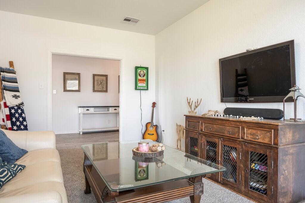 105 Montecito Lane Manvel, TX 77578 - Photo 25 of 39 a living room with furniture and a flat screen tv