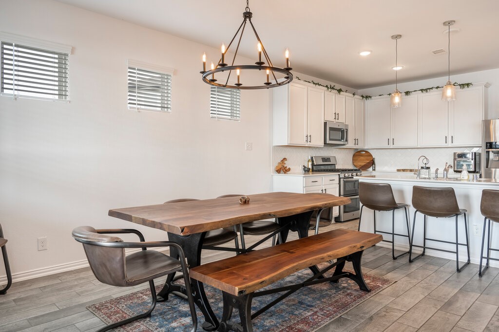 105 Montecito Lane Manvel, TX 77578 - Photo 31 of 39 a dining room with furniture and a chandelier