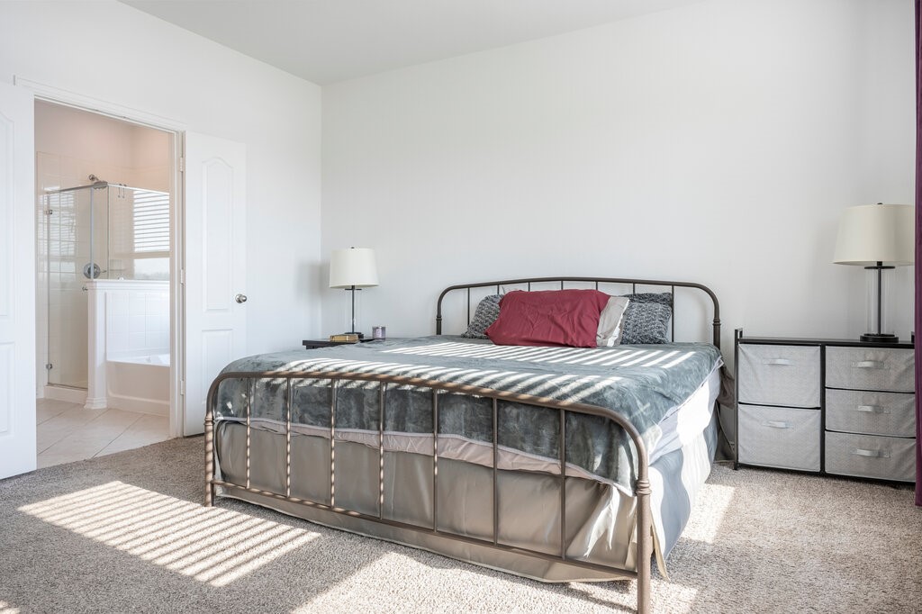 105 Montecito Lane Manvel, TX 77578 - Photo 36 of 39 a bedroom with a bed and a dresser