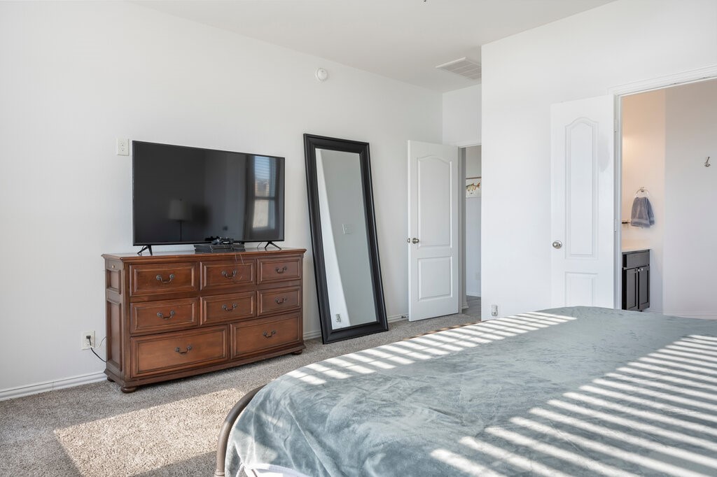 105 Montecito Lane Manvel, TX 77578 - Photo 37 of 39 a bedroom with a bed and flat screen tv