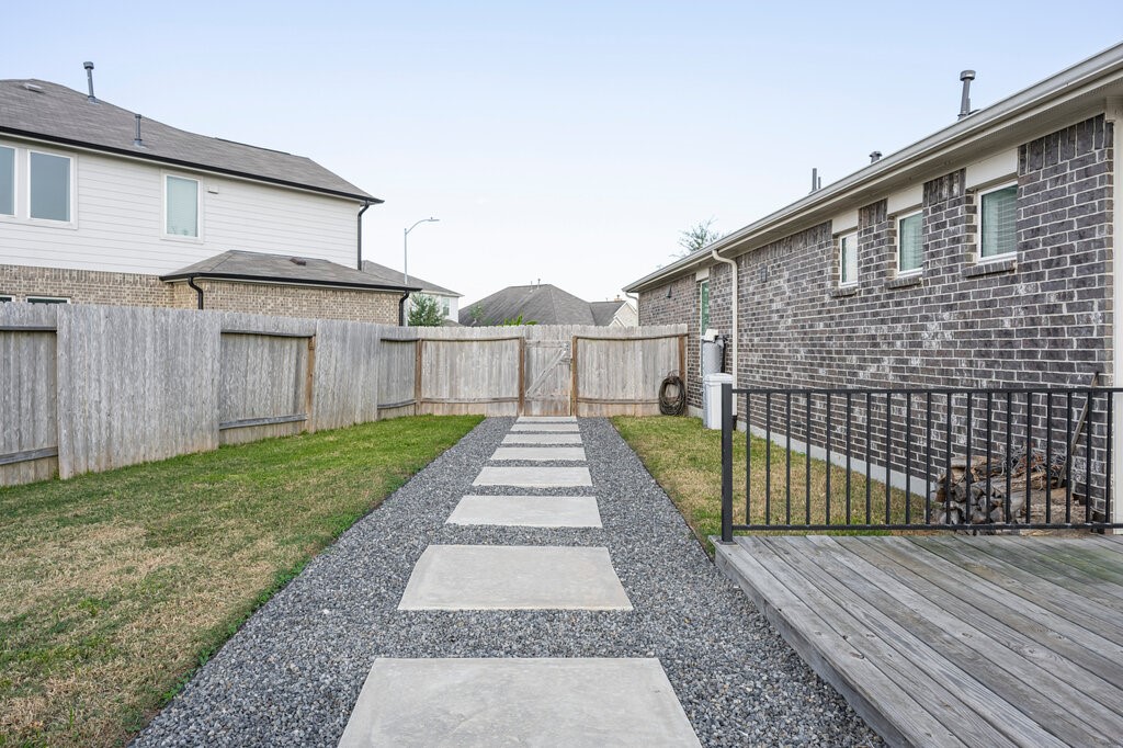 105 Montecito Lane Manvel, TX 77578 - Photo 7 of 39 a view of a brick house with a small yard and large trees