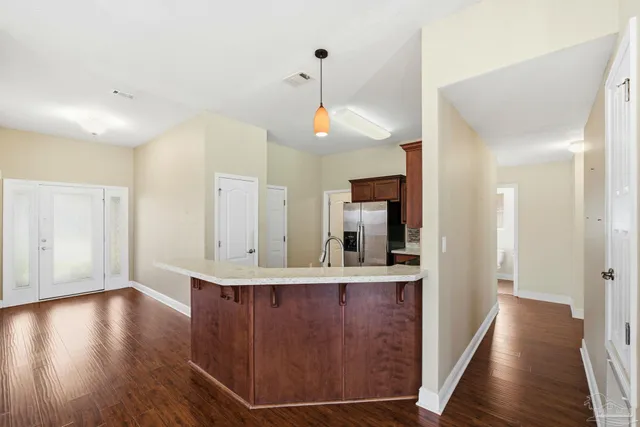 a view of a kitchen cabinets a stove and wooden floor