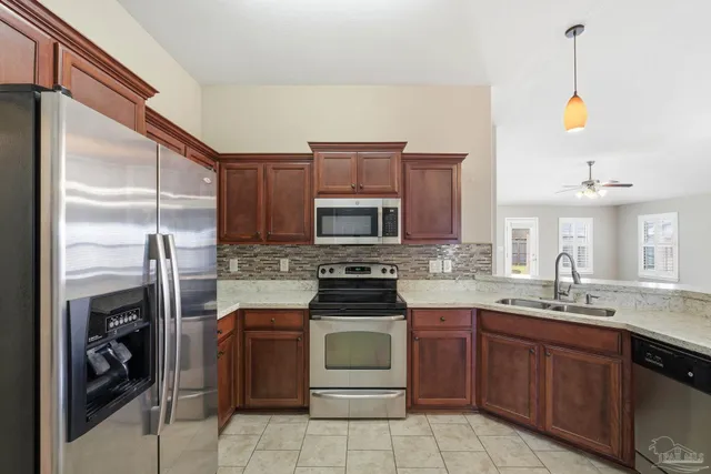 a kitchen with a sink stove and refrigerator
