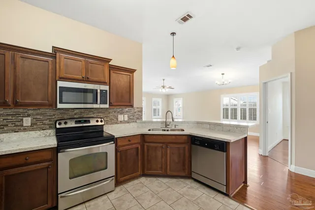 a kitchen with a sink stove and microwave
