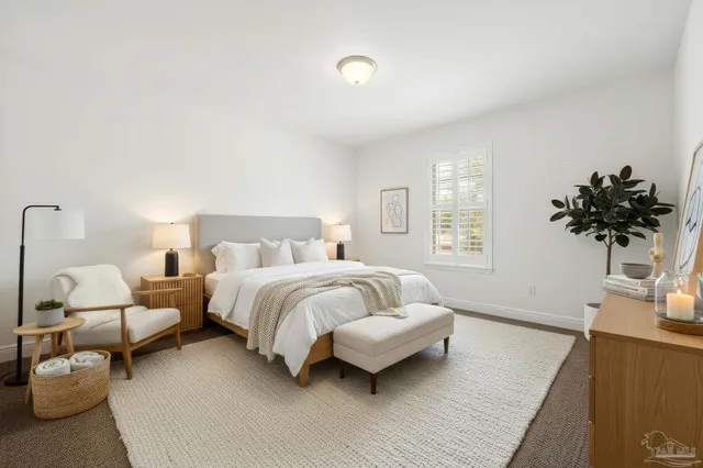 a spacious bedroom with a bed and a couch