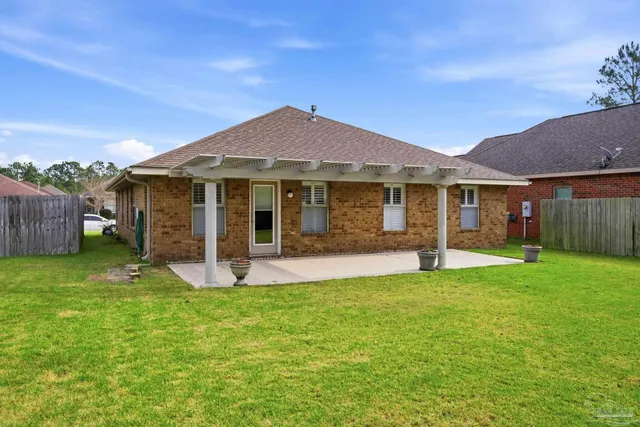 a view of a house with a yard and tree