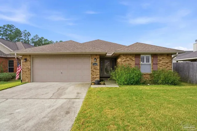 a front view of a house with yard and green space
