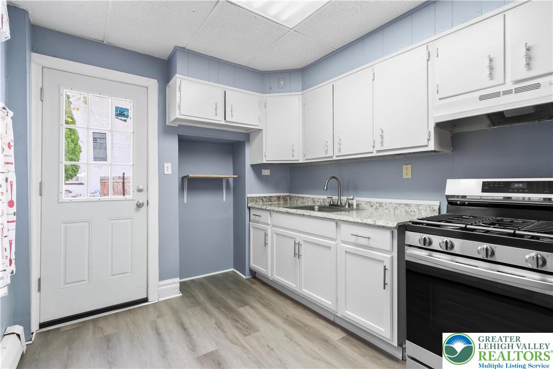 424 Cedar Street Allentown, PA 18102 - Photo 11 of 27 a kitchen with granite countertop a stove and a sink