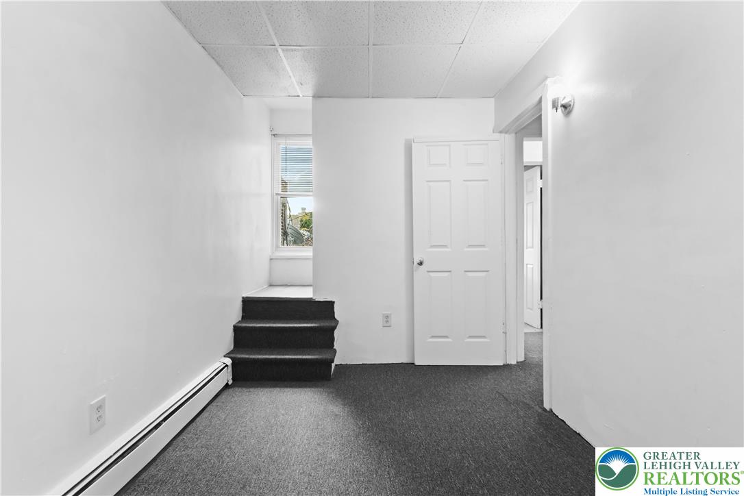 424 Cedar Street Allentown, PA 18102 - Photo 16 of 27 a view of a livingroom with wooden floor and a window