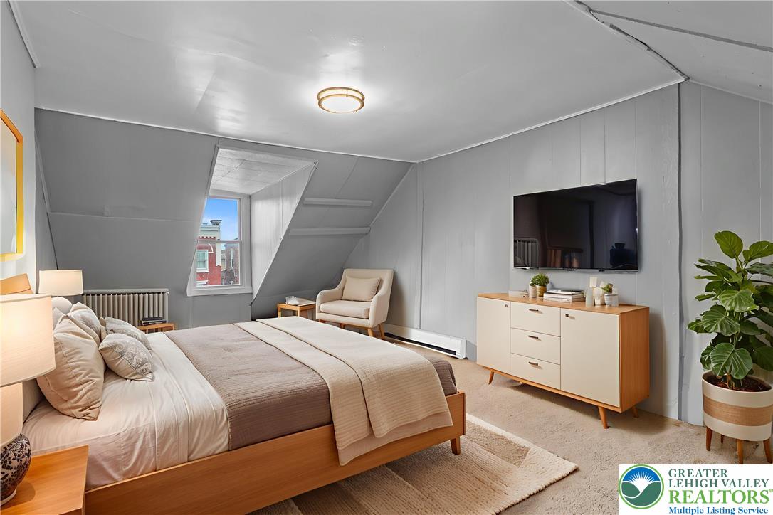 424 Cedar Street Allentown, PA 18102 - Photo 20 of 27 a bedroom with bed tv and a window