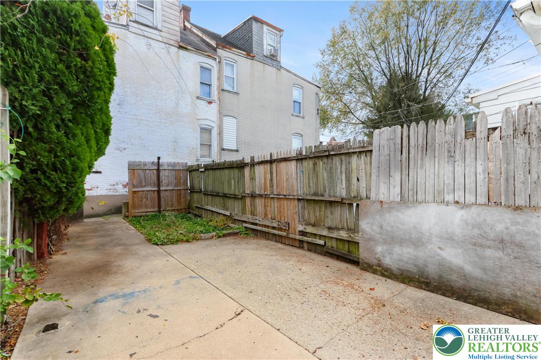 424 Cedar Street Allentown, PA 18102 - Photo 23 of 27 a view of backyard with large trees and wooden fence