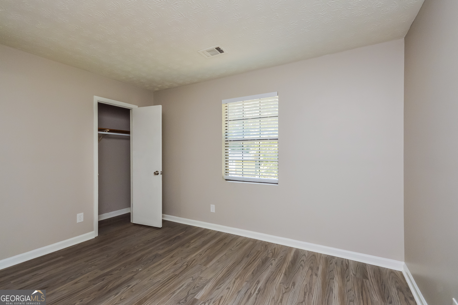 4585 Old Lake Drive Decatur, GA 30034 - Photo 11 of 16 an empty room with wooden floor and windows