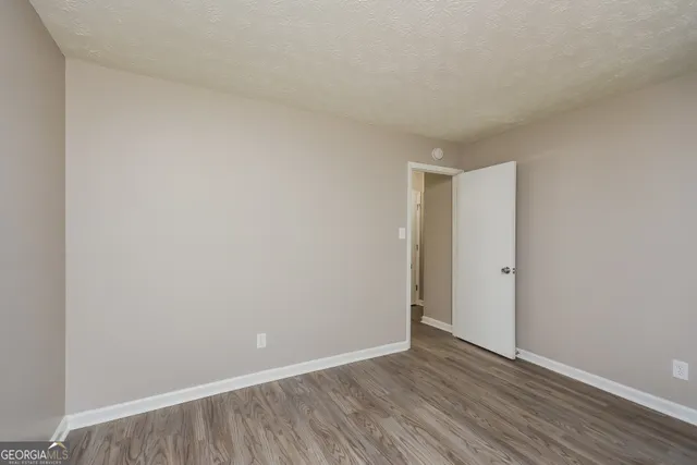 a view of an empty room and wooden floor