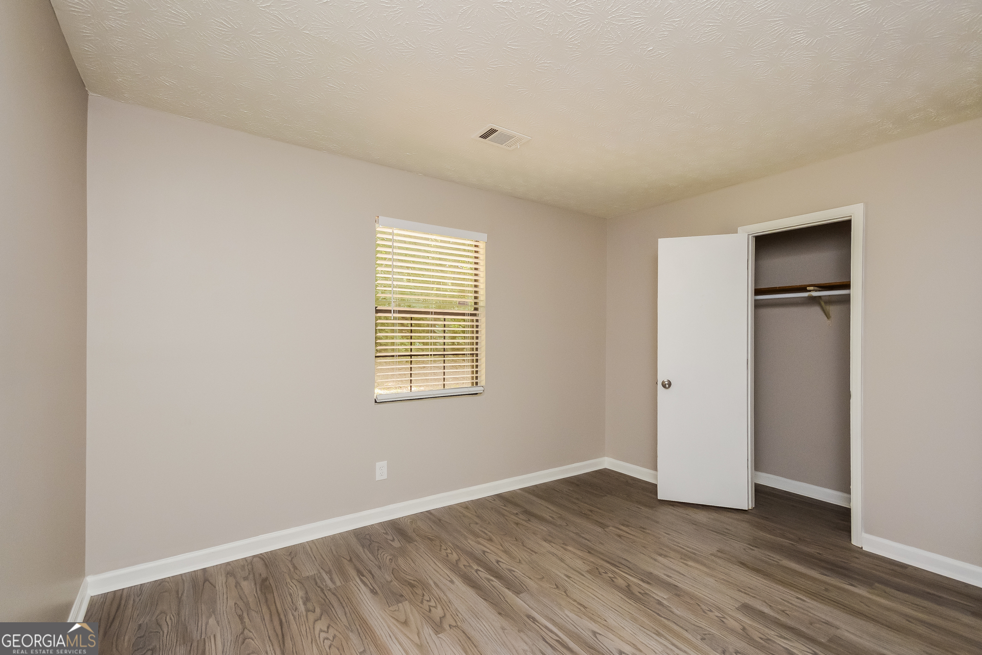 4585 Old Lake Drive Decatur, GA 30034 - Photo 13 of 16 an empty room with wooden floor and windows