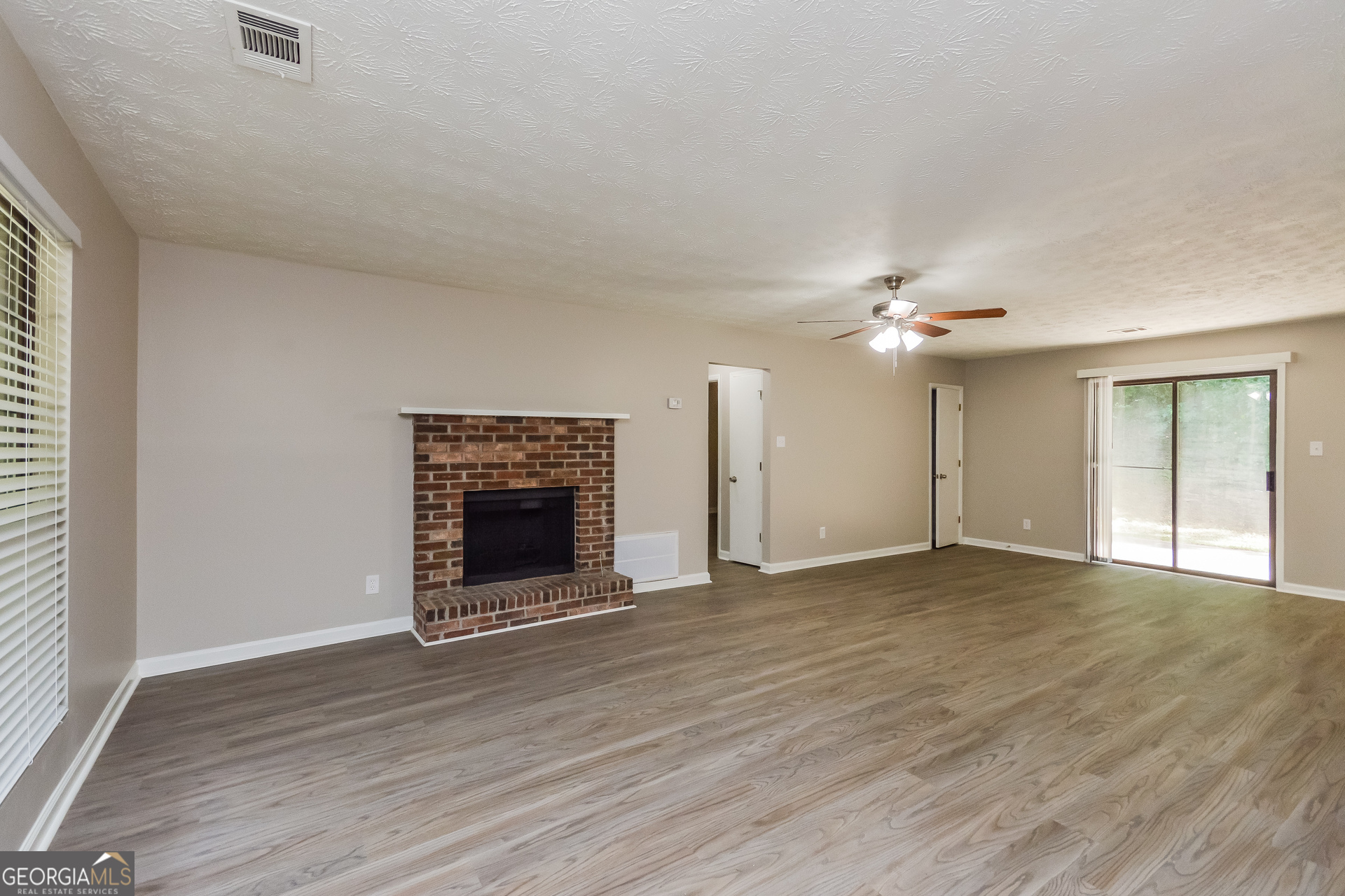 4585 Old Lake Drive Decatur, GA 30034 - Photo 2 of 16 a view of an empty room with wooden floor fireplace and a window