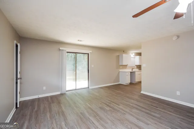 a view of a kitchen with wooden floor and a kitchen
