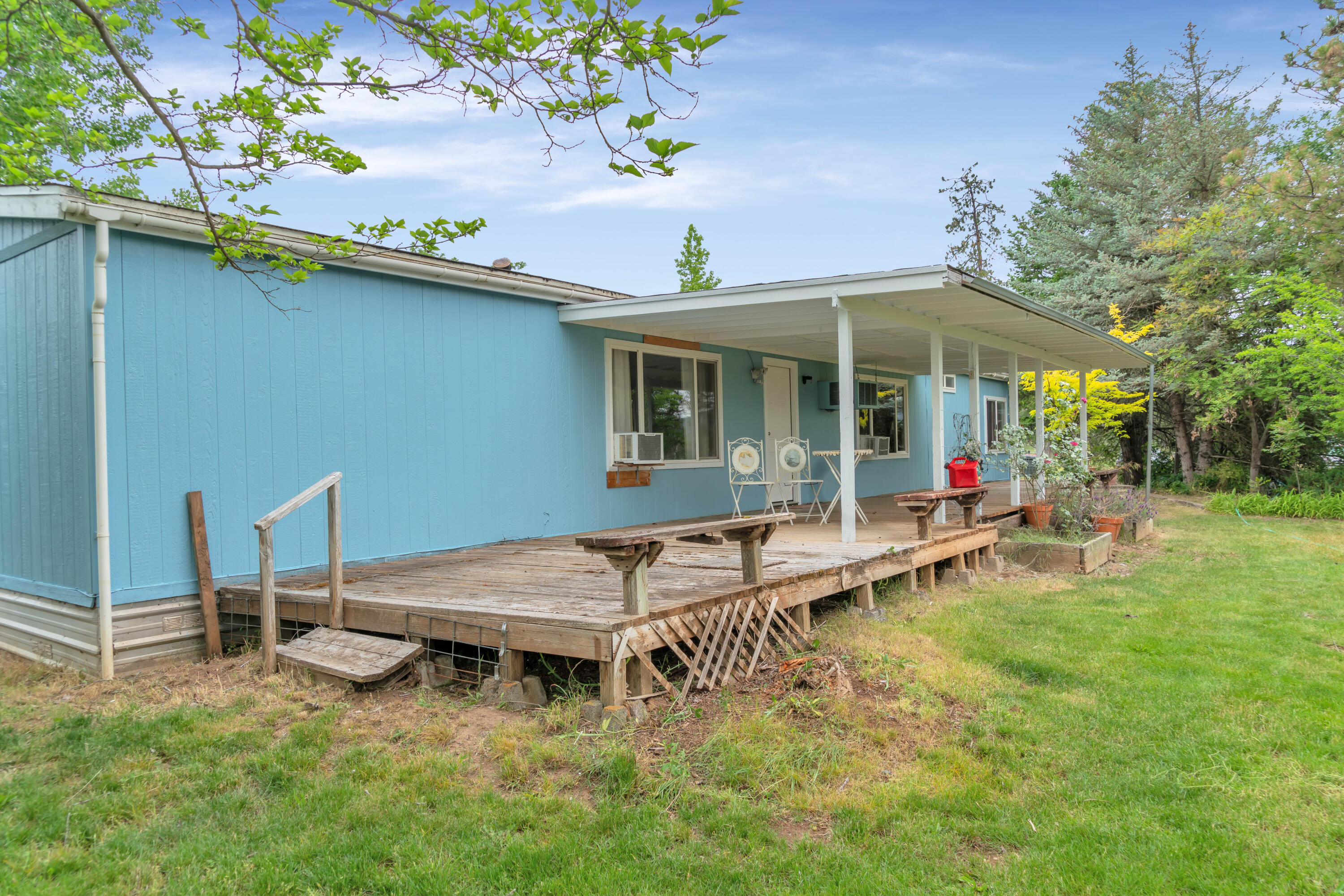 12107 Meadows Road White City, OR 97503 - Photo 9 of 36 a view of a house with a backyard and chairs