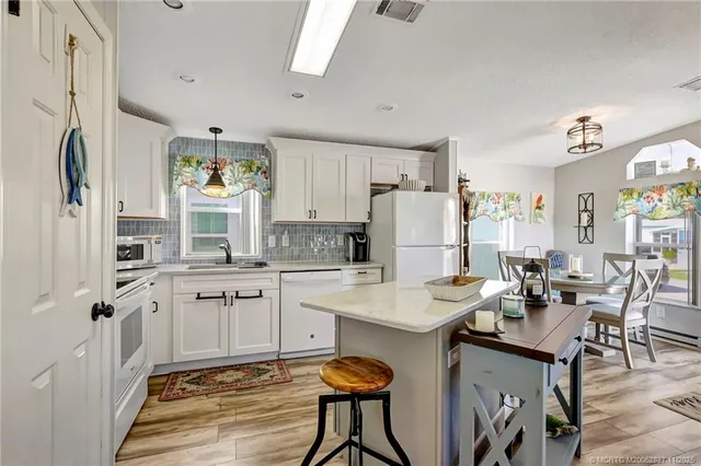 a view of a house with a yard and a tree