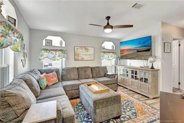 a view of a kitchen with center island and stainless steel appliances