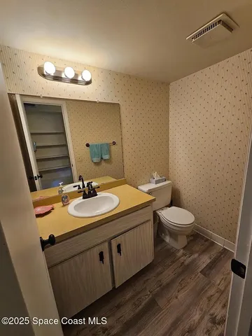 a bathroom with a sink a toilet and mirror