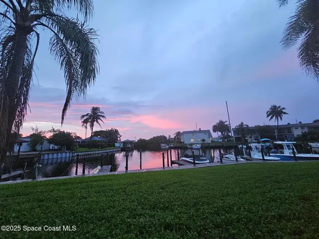 a view of a yard with a slide and a lake view