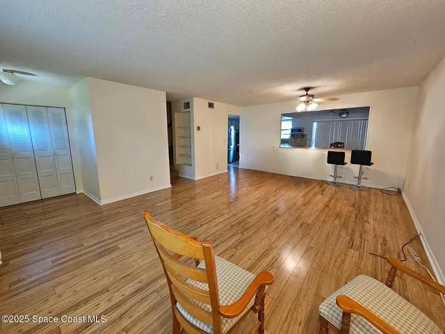 a view of a livingroom with furniture and wooden floor