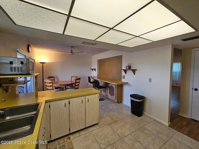 a kitchen with a sink appliances and cabinets