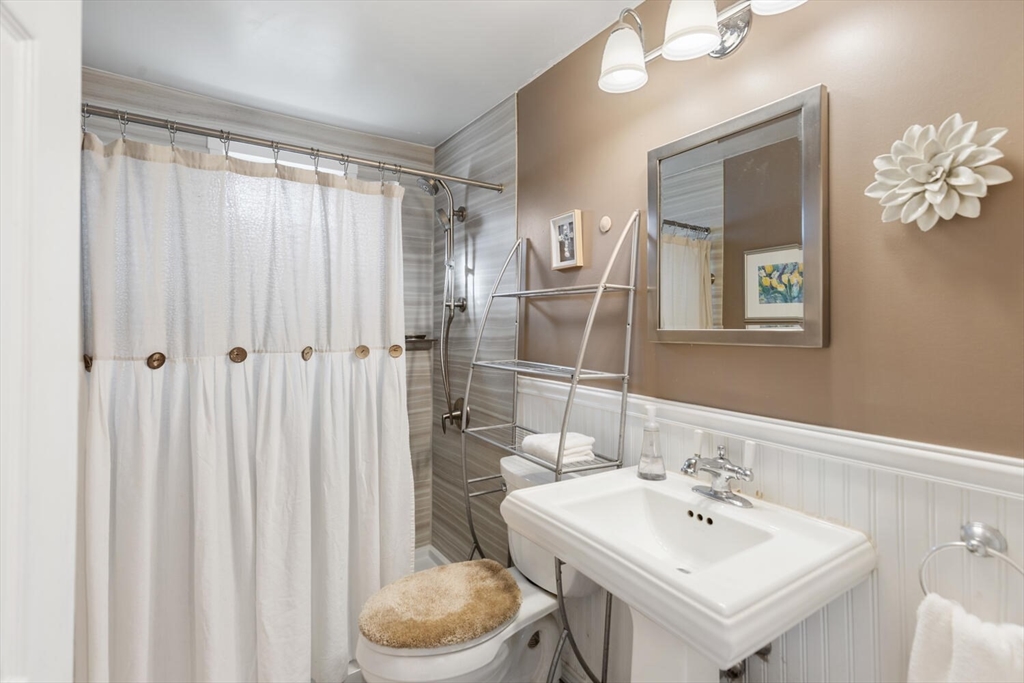 19 Dustin Young Lane Billerica, MA 01821 - Photo 18 of 37 a bathroom with a sink a toilet and shower curtain