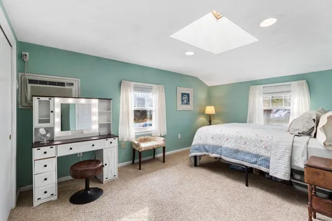 a view of a room with workspace and a window