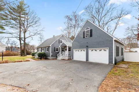 a view of a house with a snow in front of yard