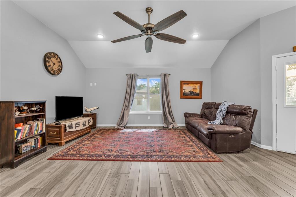 7 Market Loop Morgan's Point Resort, TX 76513 - Photo 11 of 31 Spacious living area featuring vaulted ceilings, recessed lighting, and wood-finish flooring