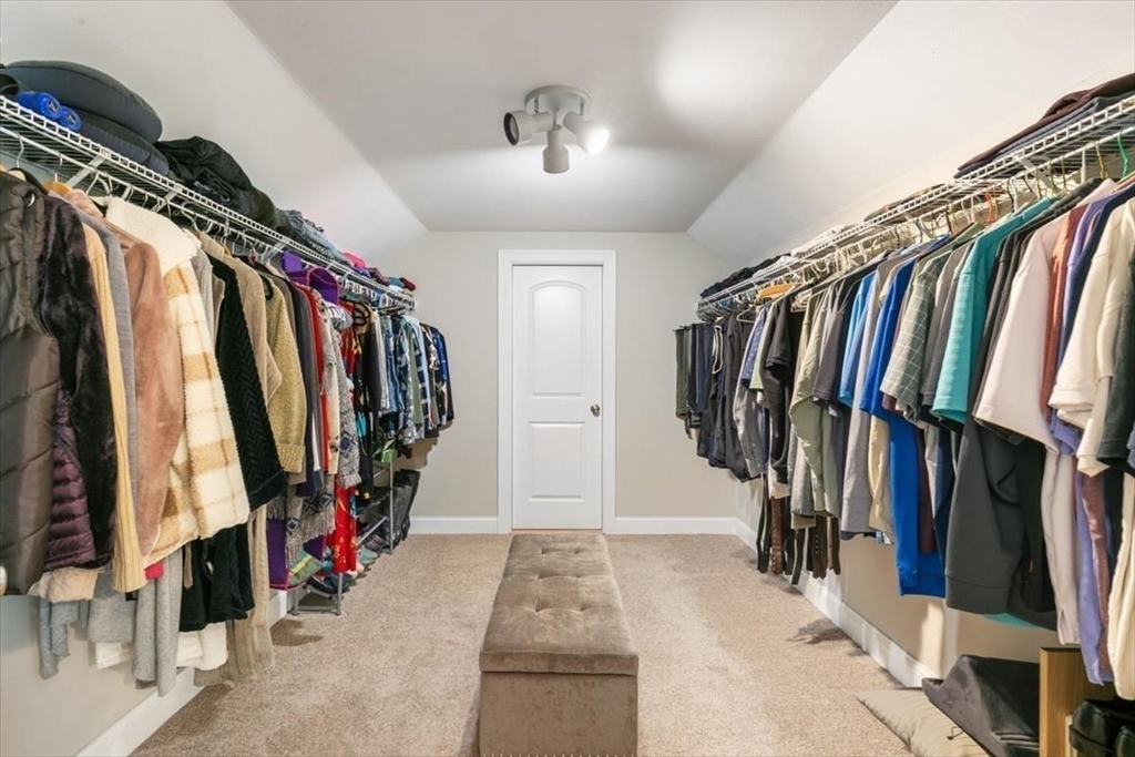 135 Pepperell Road Groton, MA 01450 - Photo 21 of 41 a view of walk in closet with clothes and shoes