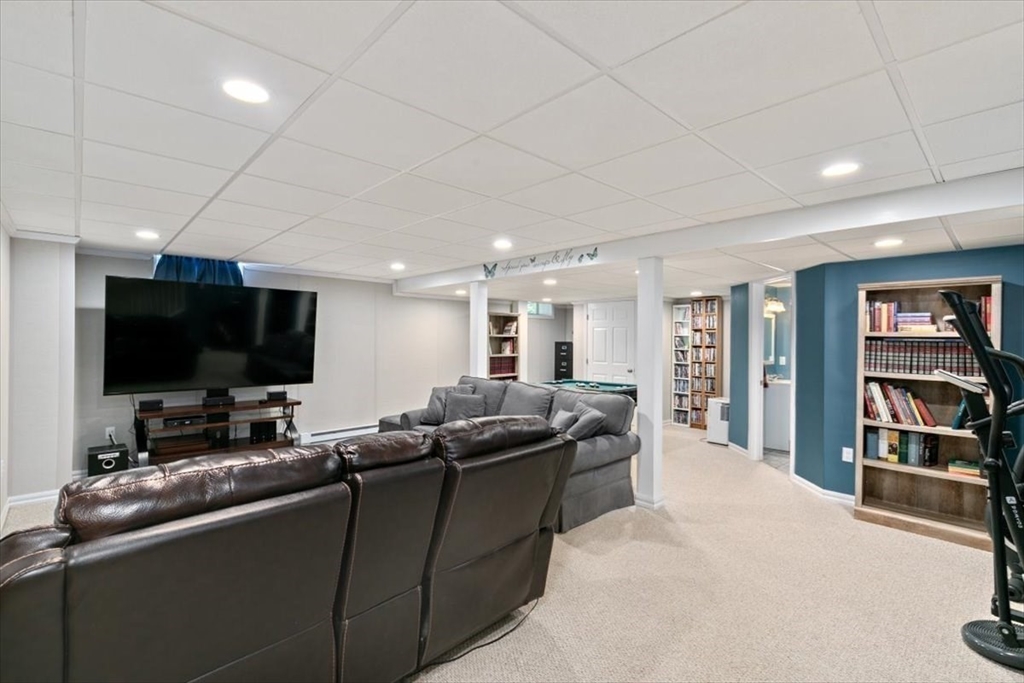 135 Pepperell Road Groton, MA 01450 - Photo 29 of 41 a living room with furniture and a flat screen tv
