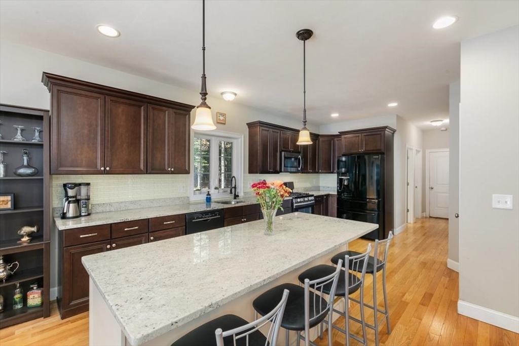 135 Pepperell Road Groton, MA 01450 - Photo 3 of 41 a large kitchen with a table and chairs