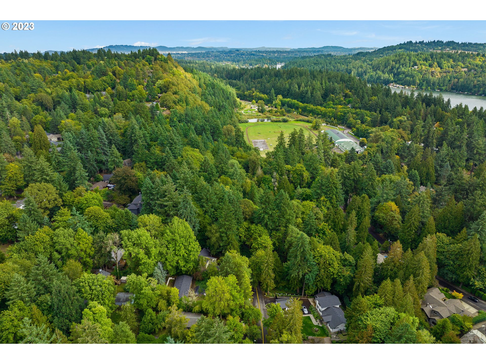 15370 Twin Fir Road Lake Oswego, OR 97035 - Photo 17 of 19 a view of a lush green forest with trees and some houses