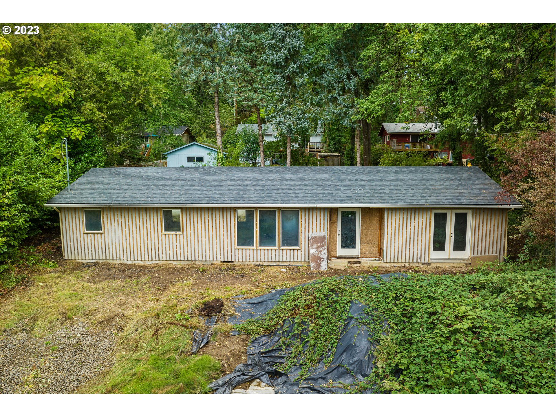 15370 Twin Fir Road Lake Oswego, OR 97035 - Photo 7 of 19 a view of a brick house next to a yard