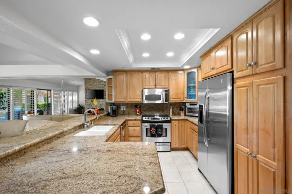 a kitchen with refrigerator a sink and a counter top space