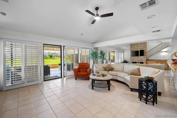 a living room with furniture and a large window