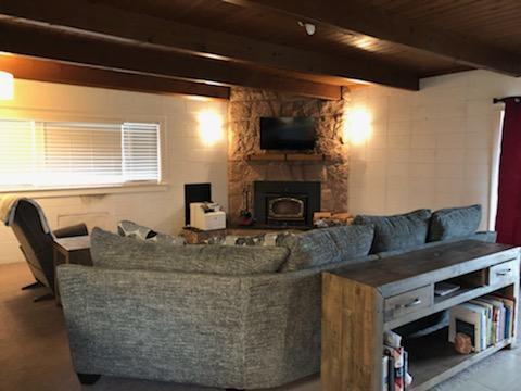 2850 South River Road Grants Pass, OR 97527 - Photo 6 of 26 a living room with furniture a flat screen tv and a fireplace