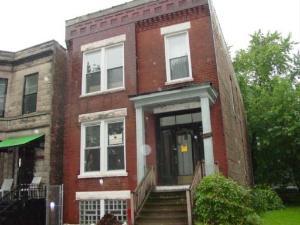 6618 South Marquette Road, Unit 1 Chicago, IL 60637 - Photo 1 of 1 front view of a brick house with a small yard