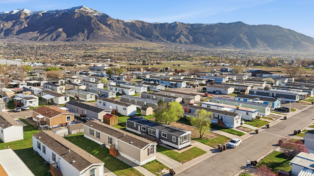 2491 Highway 89, Unit 523 Pleasant View, UT 84404 - Photo 29 of 31 Aerial overview of property's location featuring nearby suburban area and a mountain backdrop