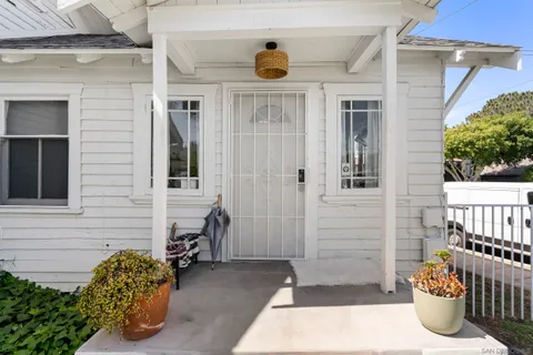 a view of a chair and table in backyard of the house